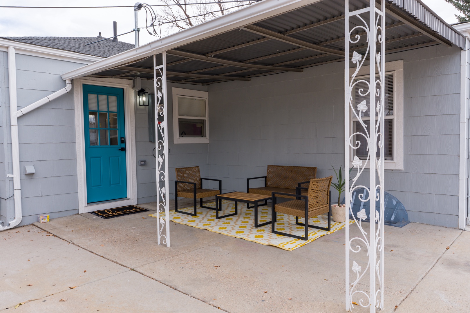 Your private covered patio offers a perfect outdoor retreat with comfortable seating and charming decorative touches.