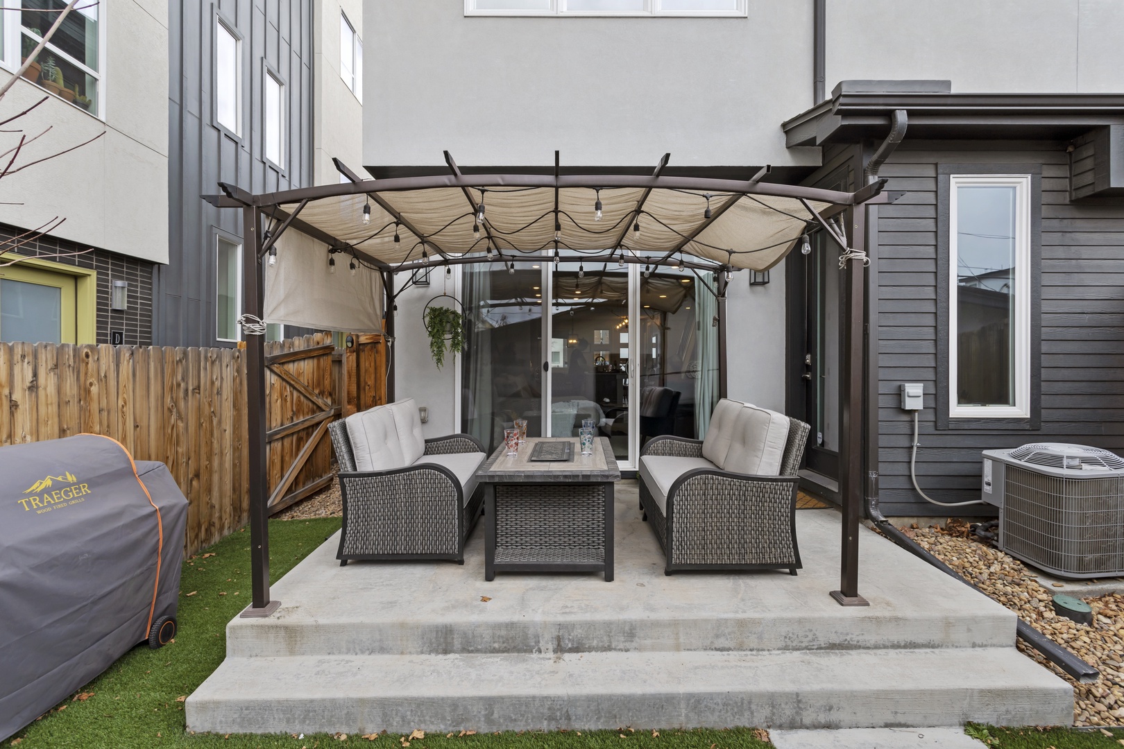 Relax in your private covered patio with comfortable wicker seating and BBQ grill, perfect for outdoor dining and entertaining.