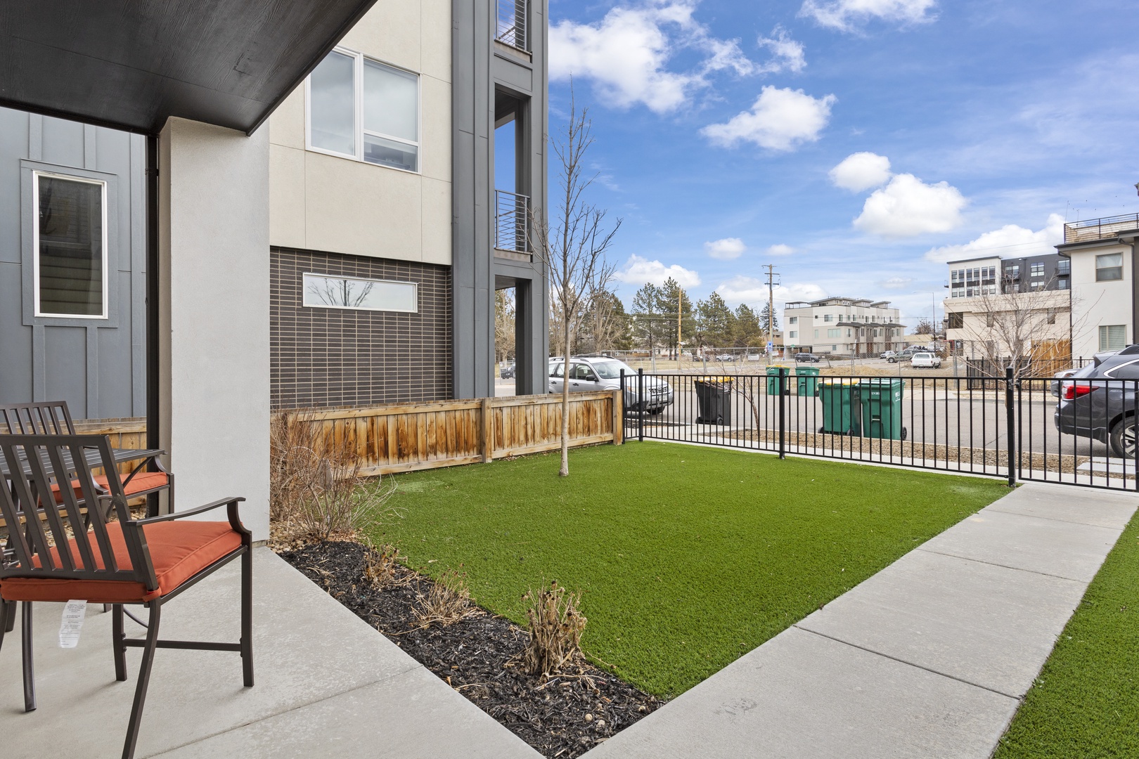 Modern property with landscaped green space and contemporary buildings in a vibrant neighborhood setting.