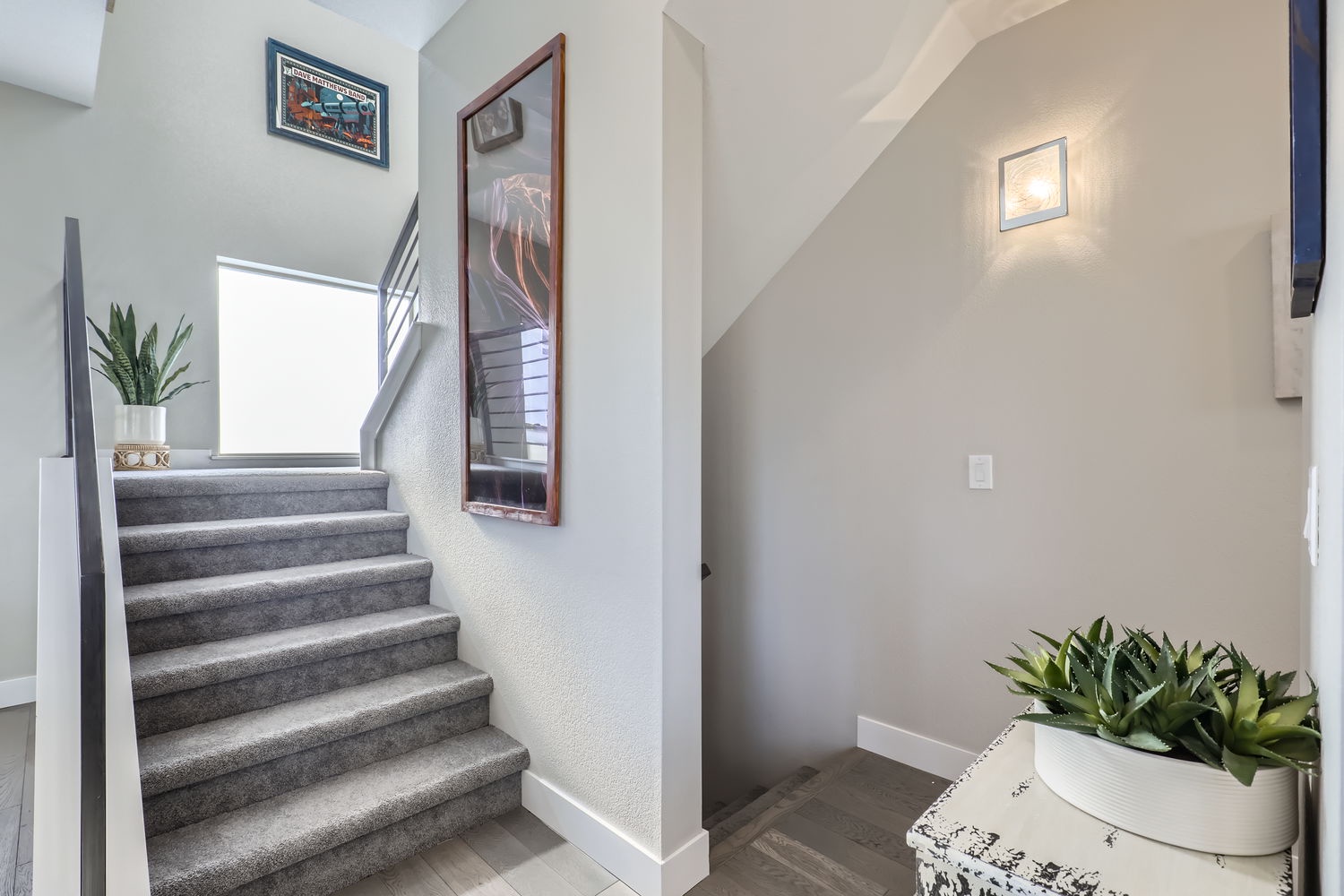 Step inside and feel instantly at home. This bright, airy entryway welcomes you with soft neutral tones, modern coastal art, and touches of greenery that make arriving feel like a breath of fresh air.