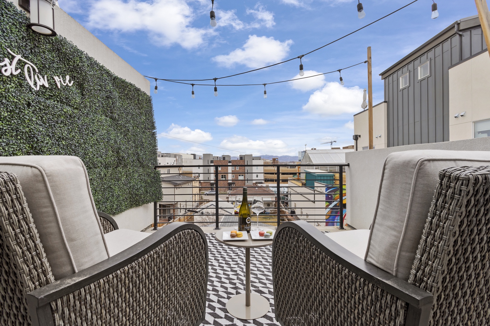 Relax on your private rooftop terrace with stylish seating and string lights overhead, perfect for enjoying drinks while taking in city views.