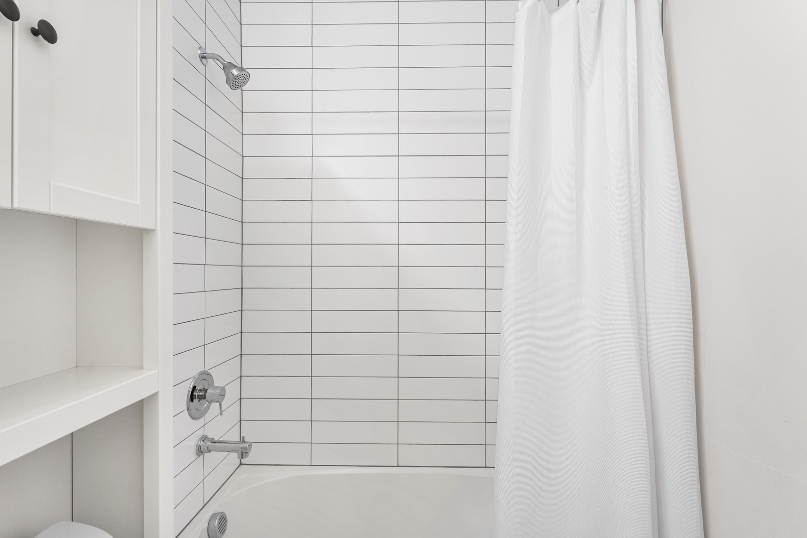 Step into your bright, spotless bathroom where crisp white tiles and clean lines create a calm retreat. The rainfall shower awaits to refresh you after every adventure.
