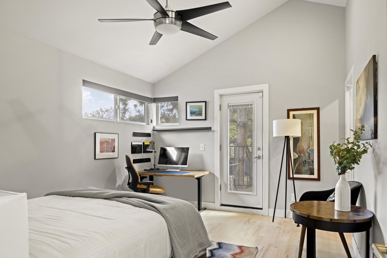 Unwind in your bright bedroom featuring a dedicated workspace, private balcony access, and modern amenities for a perfect blend of comfort and productivity.