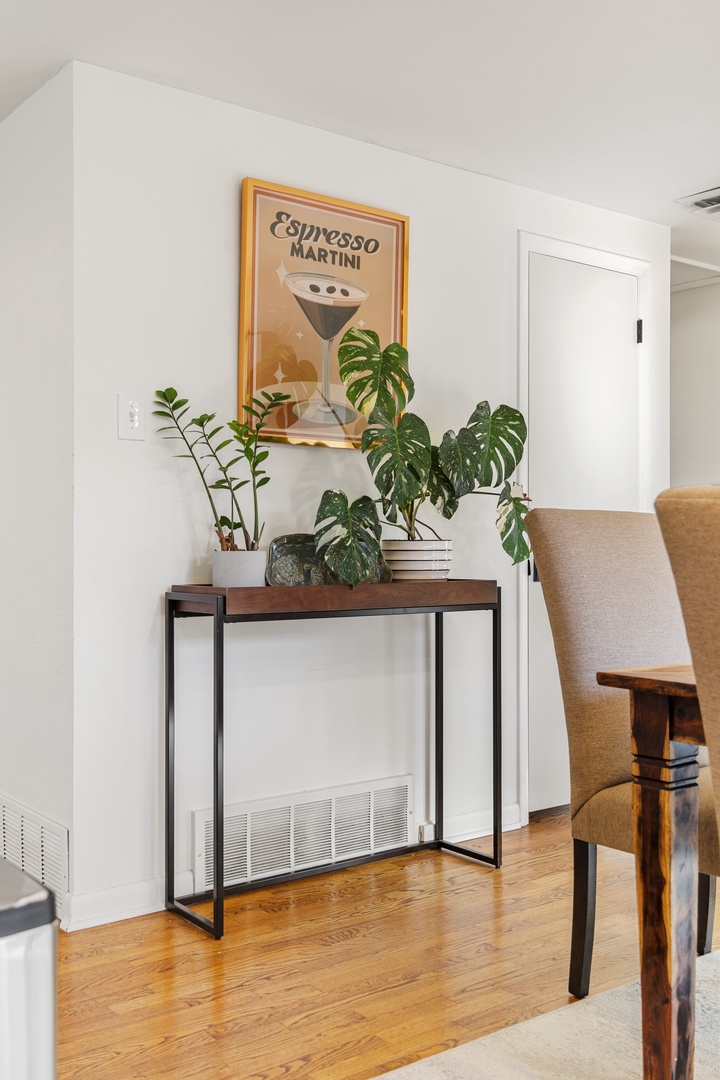 Unwind in your stylishly curated space where vintage charm meets modern comfort, complete with lush greenery and artistic touches.