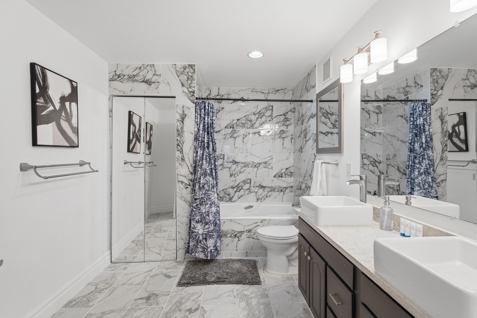 Step into your spa-like bathroom with sleek marble finishes, dual sinks, a glass-enclosed shower, and a relaxing tub—your personal retreat awaits.