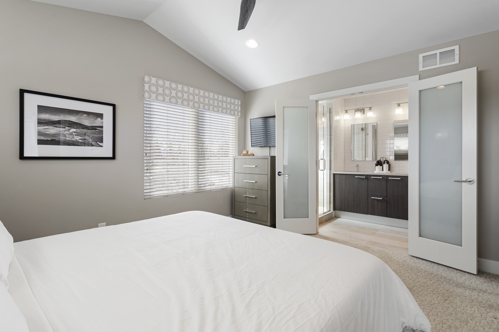 Rest peacefully in your elegant bedroom featuring crisp linens, modern decor, and an ensuite bathroom for your convenience.