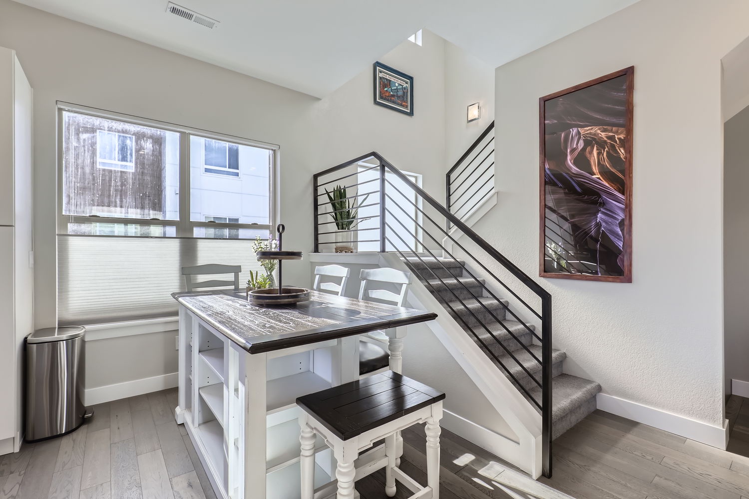 Gather around this charming dining table where you'll enjoy your morning coffee with natural light streaming through the window, or plan your day's adventures in this inviting space.