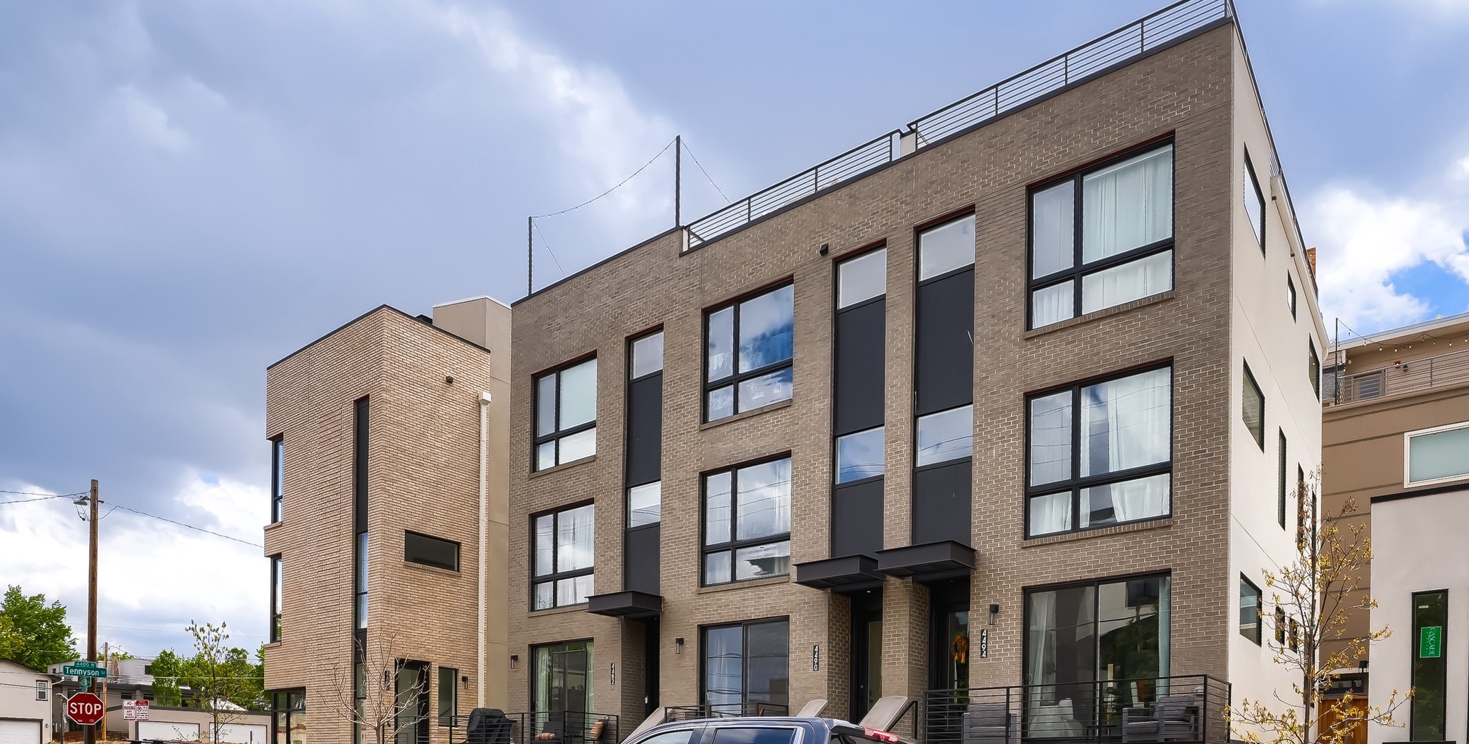 Modern townhome architecture with sleek brick facade and contemporary window design marks the arrival to this urban retreat.