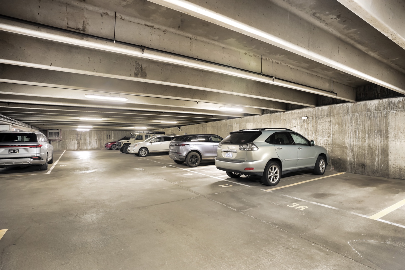 Underground parking garage with designated spaces for guest vehicles, providing secure and convenient on-site parking during your stay.