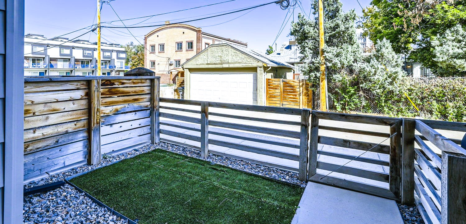 Your private terrace features artificial grass and modern fencing, perfect for morning coffee with neighborhood views.