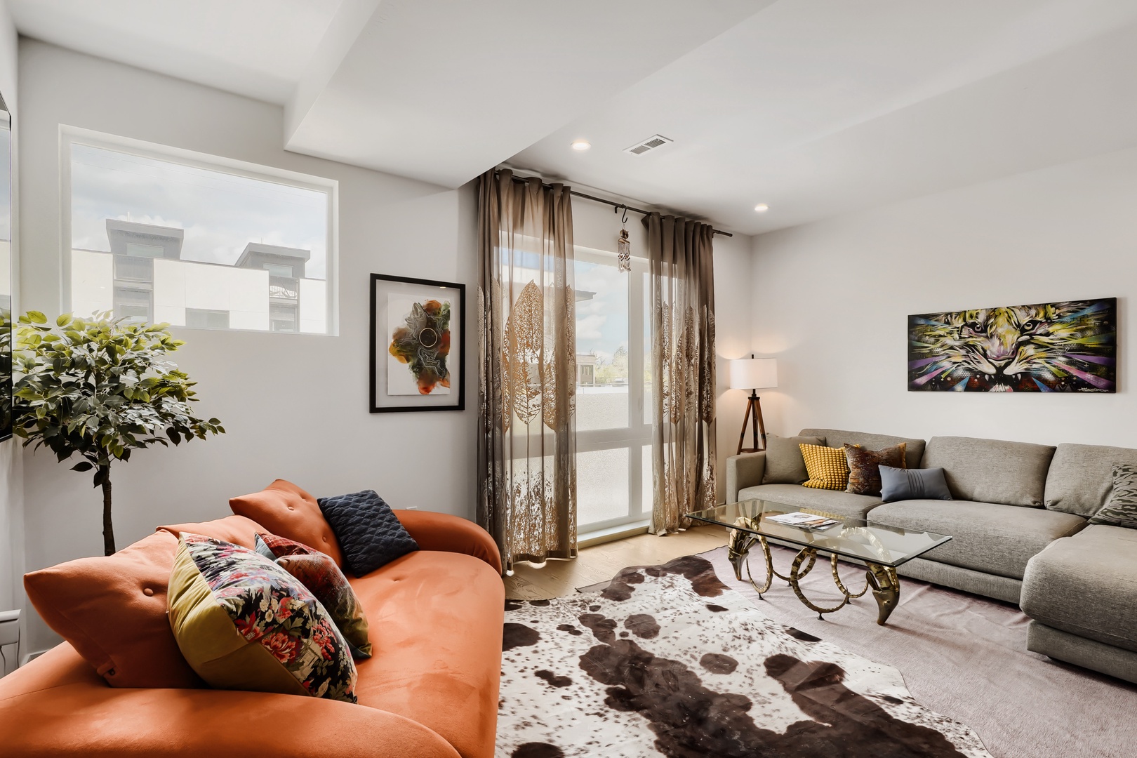 Sink into plush seating and let natural light wash over you—this inviting living space is where your mornings and evenings find their perfect rhythm.