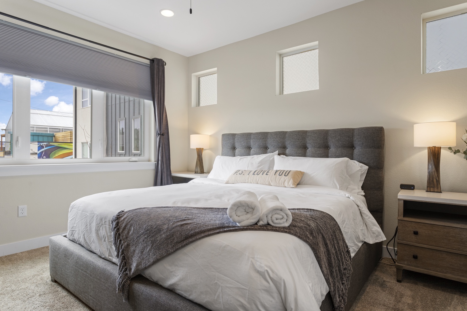 Sink into crisp linens and plush pillows in your serene bedroom sanctuary, where soft lighting and thoughtful touches await your arrival.