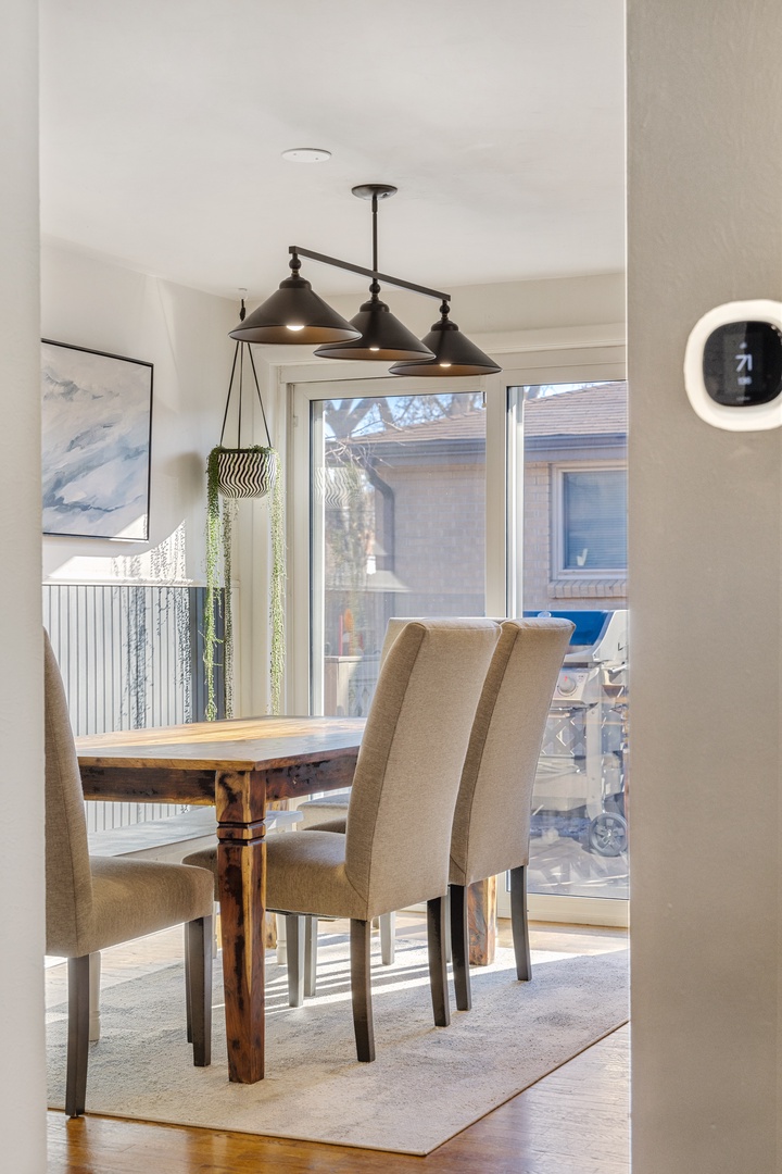 Your stylish dining space features warm wood table, comfortable seating, and modern pendant lighting for memorable meals together.