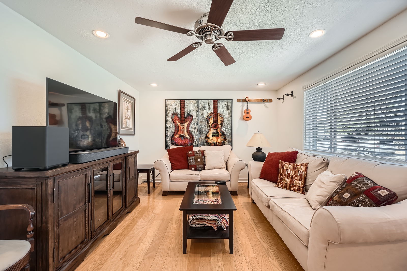 Sink into plush seating while guitar art creates a musical vibe in your bright, comfortable living space.