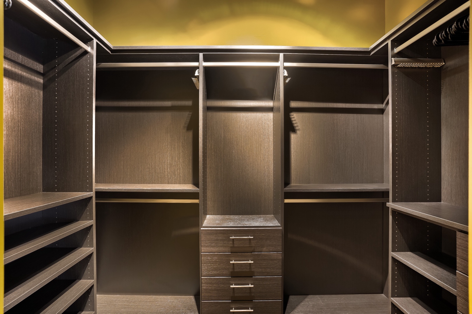 Discover your spacious walk-in closet with customizable shelving and hanging space, designed to keep your wardrobe perfectly organized throughout your stay.
