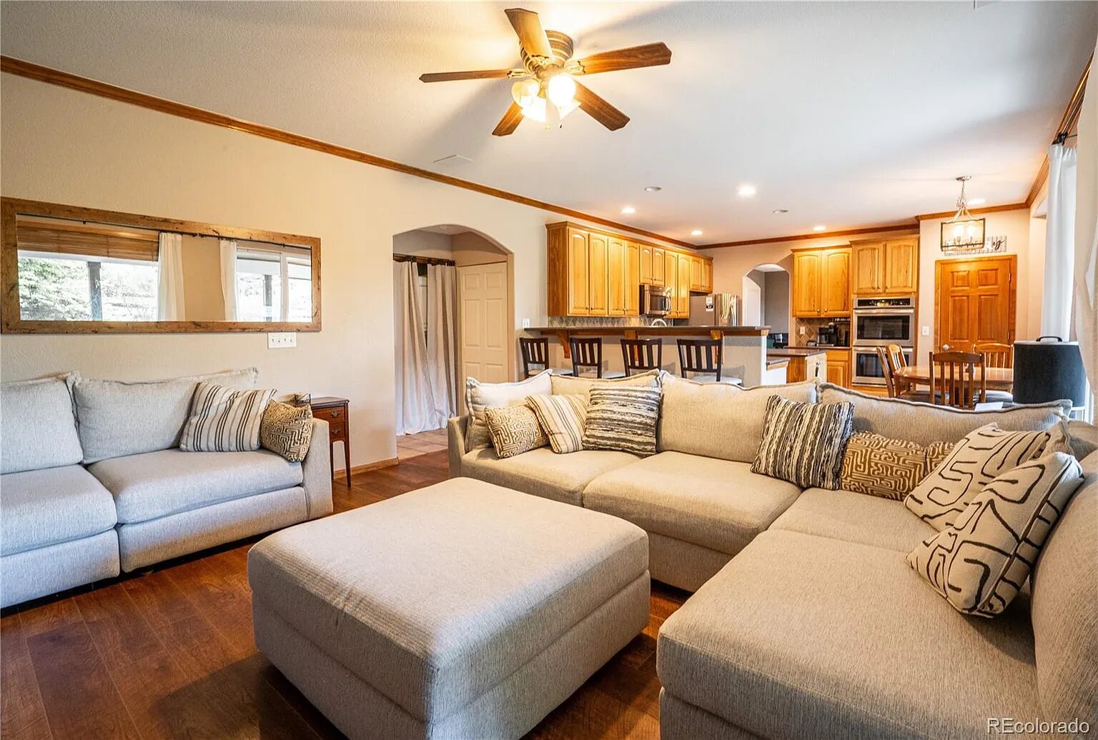 Sink into plush sectional seating in your spacious living area, where natural light streams through windows and the open kitchen awaits your culinary adventures.