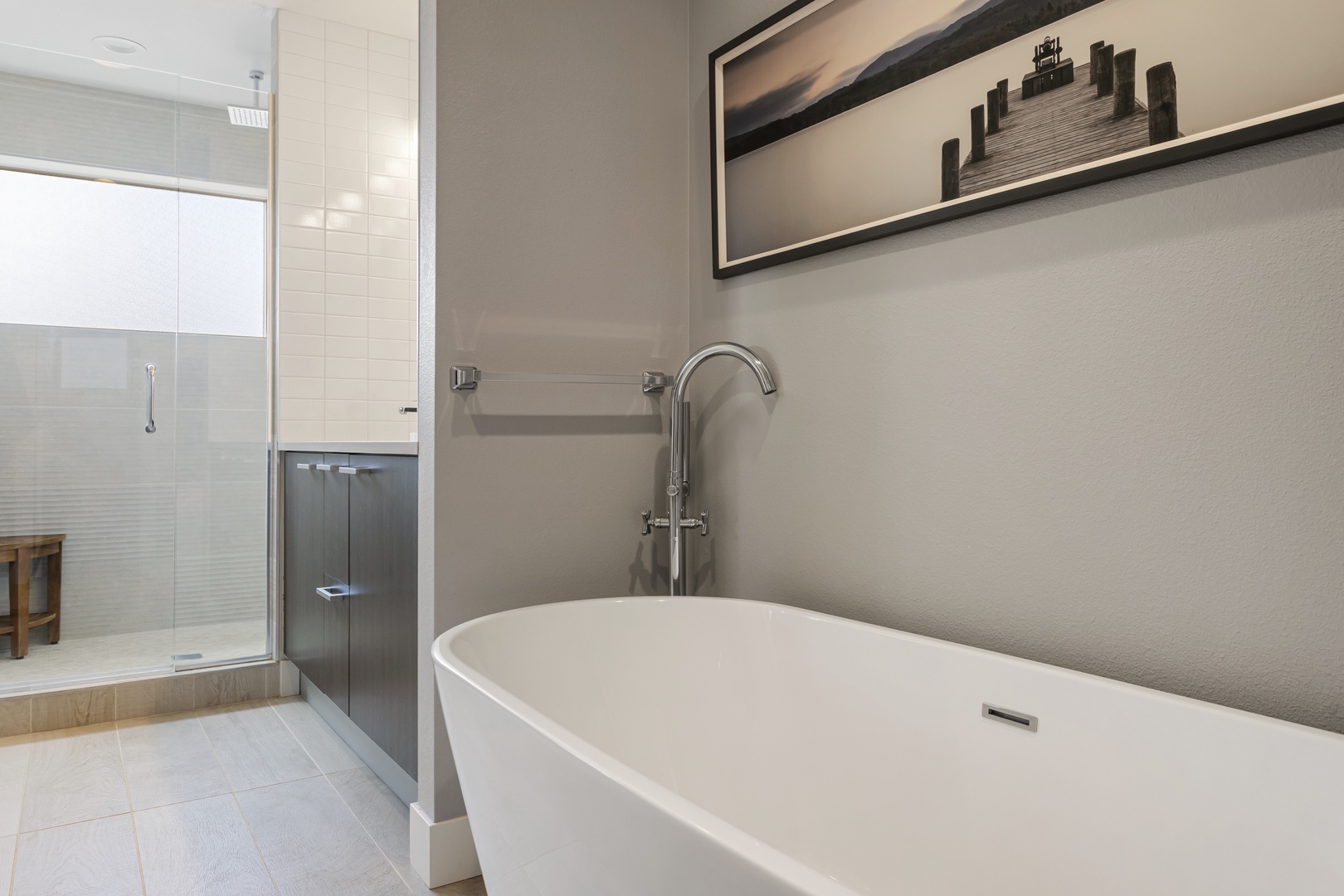 Soak your stress away in this elegant freestanding tub, perfectly positioned for ultimate relaxation with serene artwork to inspire peaceful moments.