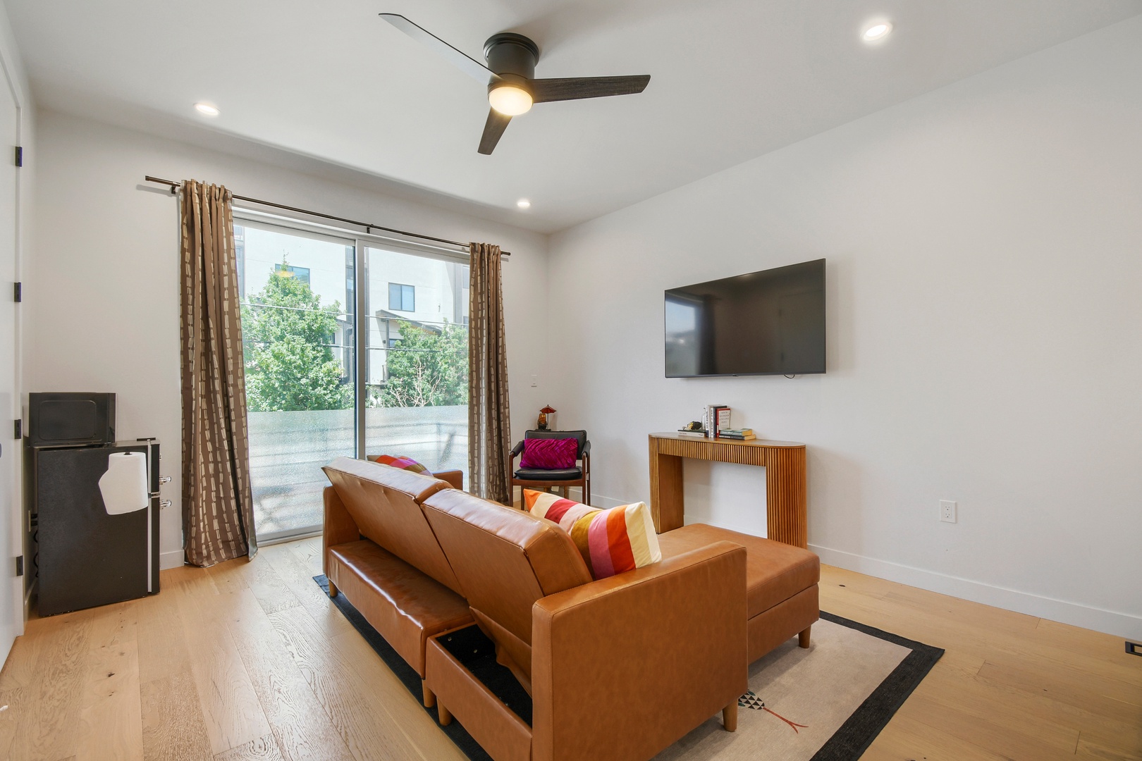 Relax in your bright living space with stylish furnishings and modern touches. Natural light streams through the balcony doors, while the ceiling fan keeps you comfortable year-round.