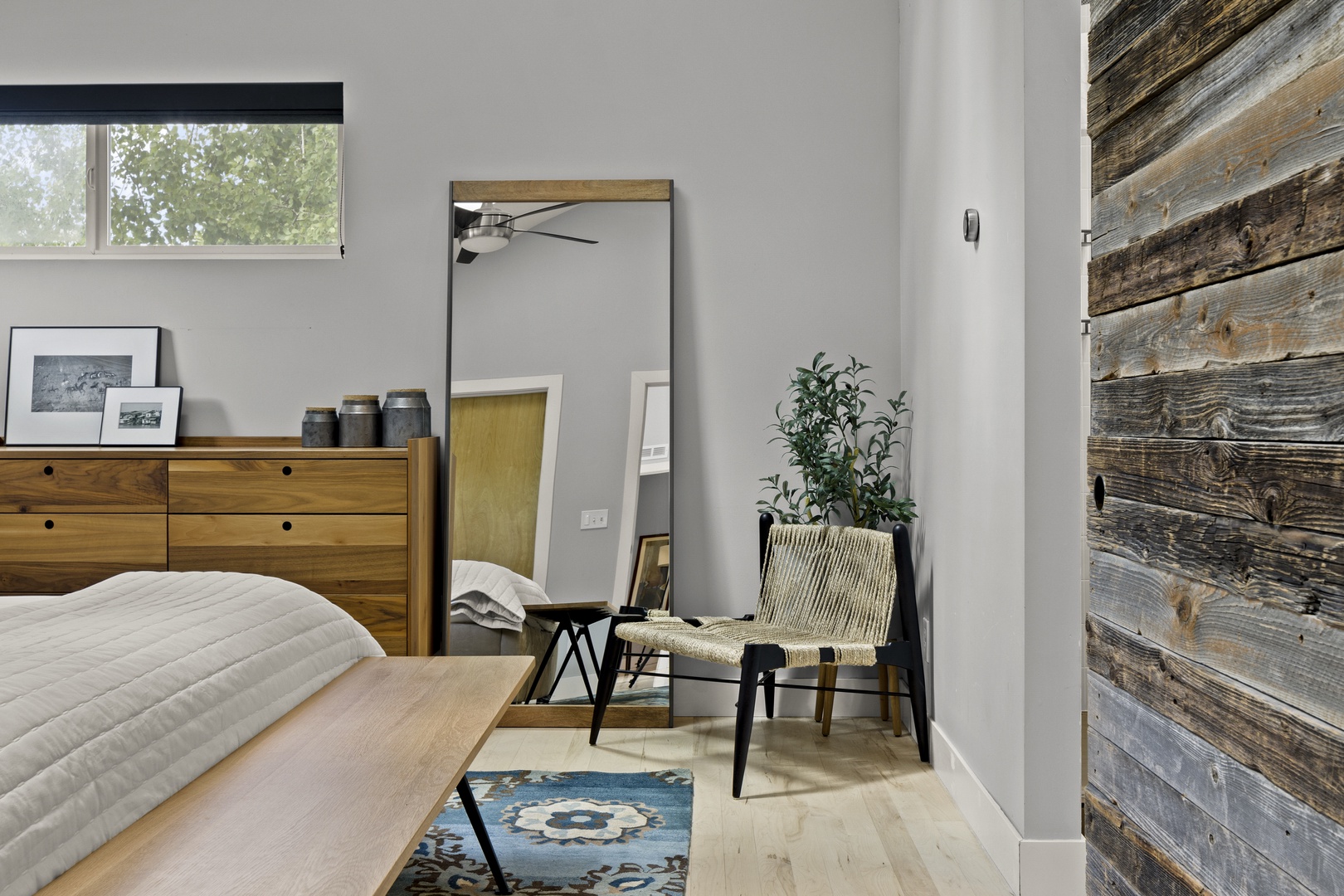 Unwind in your stylish bedroom featuring warm wood accents, modern furnishings, and thoughtful design details that create the perfect retreat.