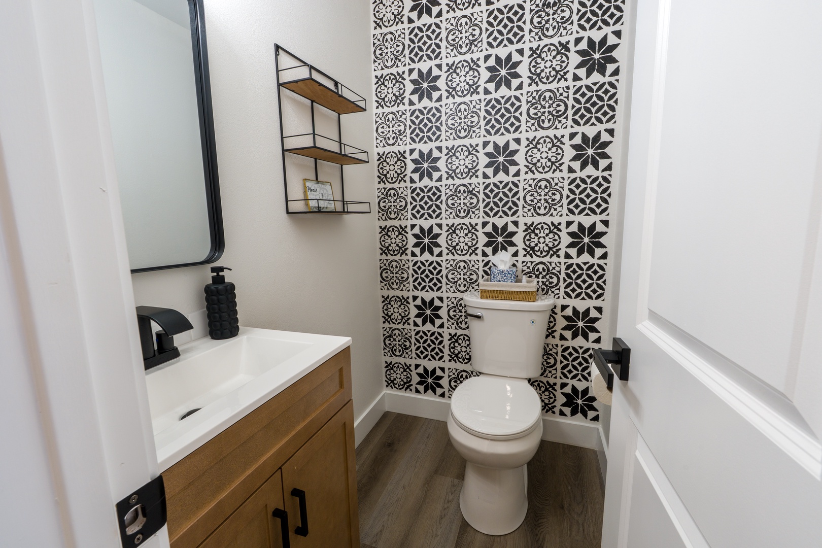 Step into your stylish powder room featuring stunning geometric tile and warm wood vanity for a sophisticated touch.