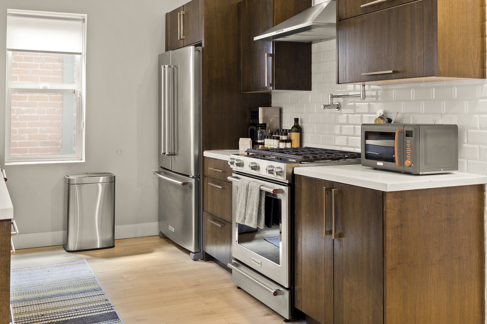 Your fully-equipped modern kitchen features sleek appliances and warm wood cabinets, perfect for preparing memorable meals during your stay.