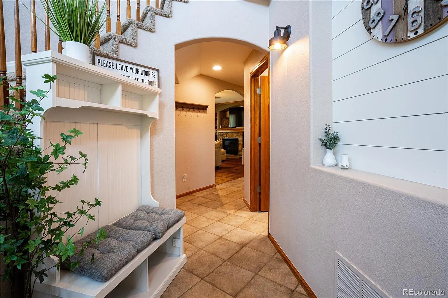 Step into your welcoming entryway where thoughtful details like the cozy bench and charming decor create an instant sense of home.