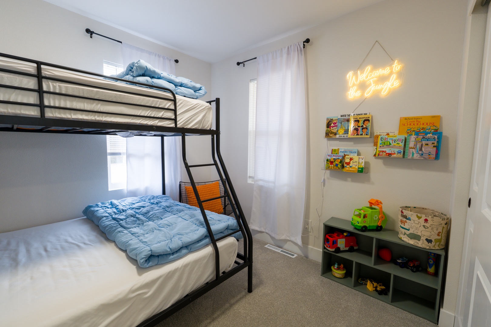 Your little ones will love this cozy kids' room with bunk beds, toys, and bedtime stories waiting on shelves.