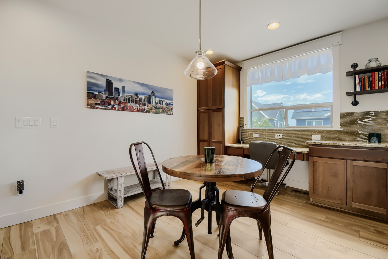 Picture yourself sipping morning coffee at this charming round table, bathed in natural light from the oversized window. The sleek kitchenette with its elegant backsplash is ready for your culinary adventures.