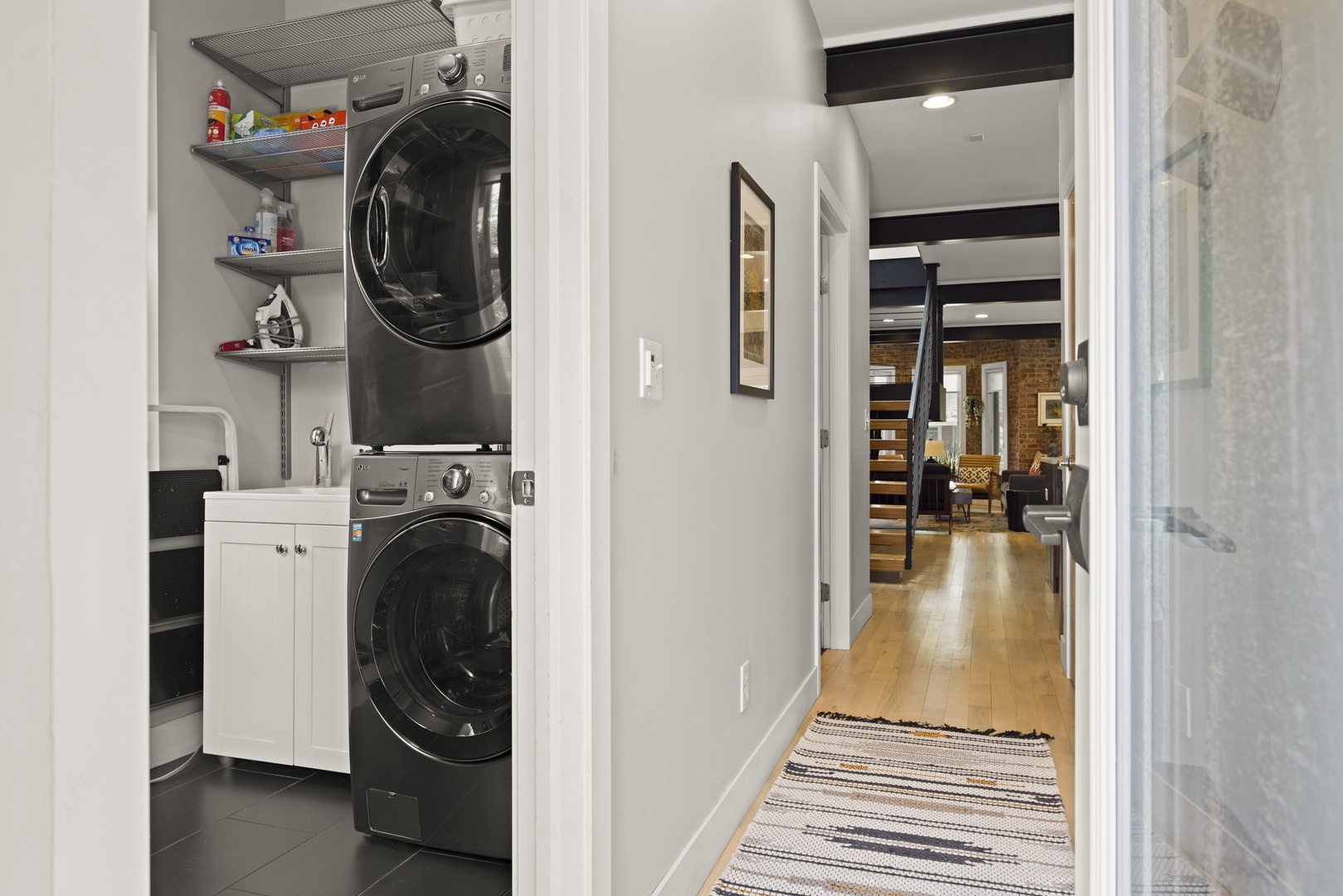 Your in-unit washer and dryer make extended stays effortless, with convenient shelving for supplies and easy access to the open living area.