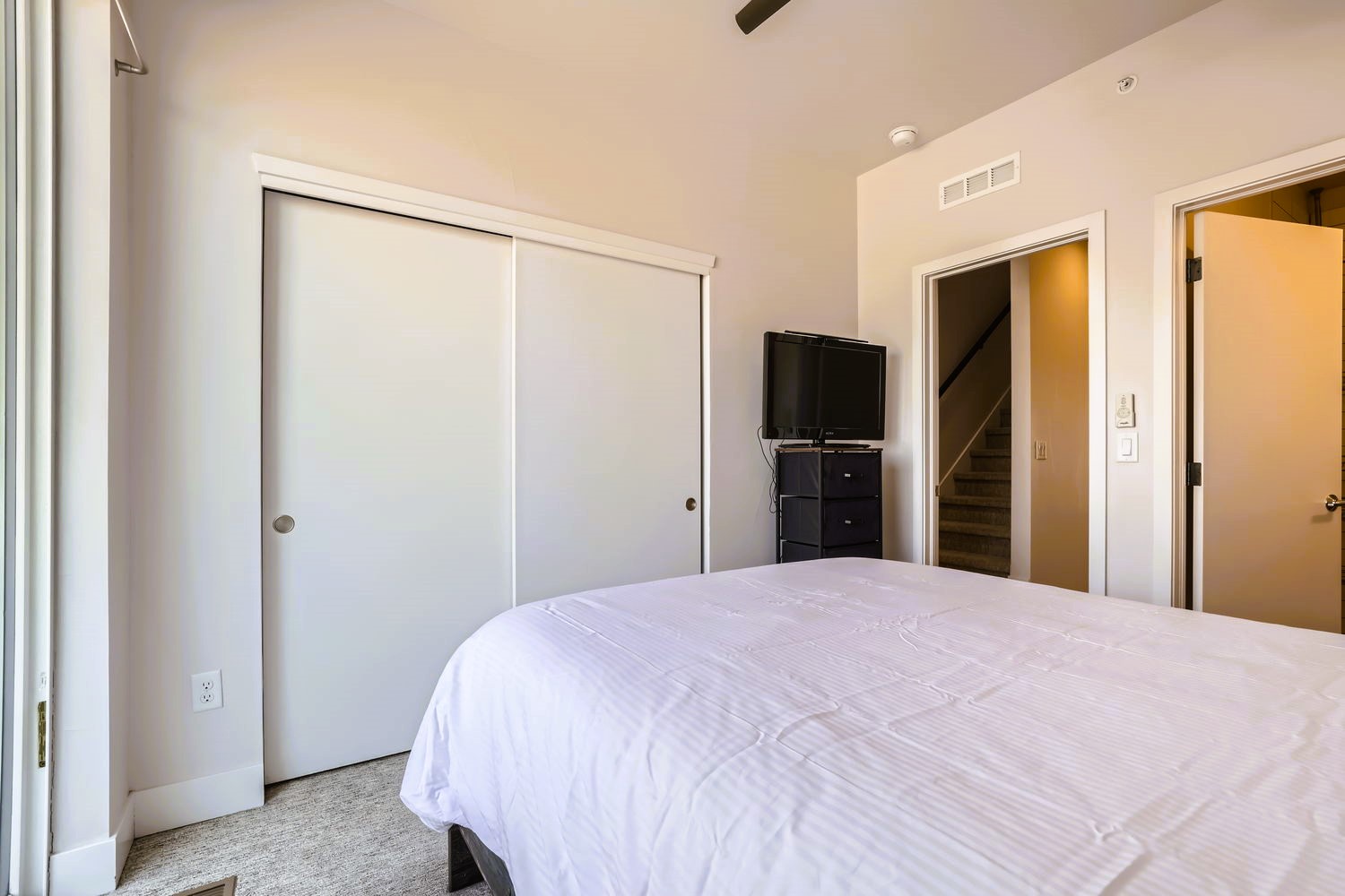 Settle into your peaceful bedroom featuring a plush bed and entertainment center, with ample closet storage for your belongings.