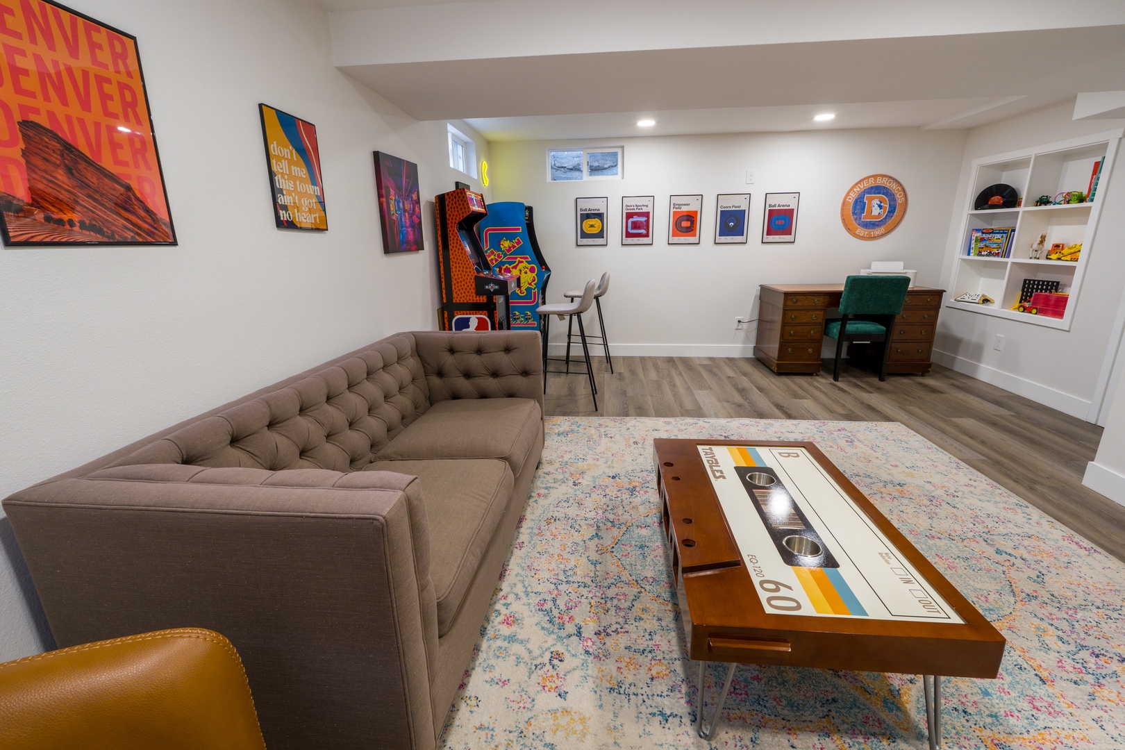 Unwind in your retro-themed game room with comfy seating, classic arcade games, and vintage vinyl records creating the perfect entertainment escape.