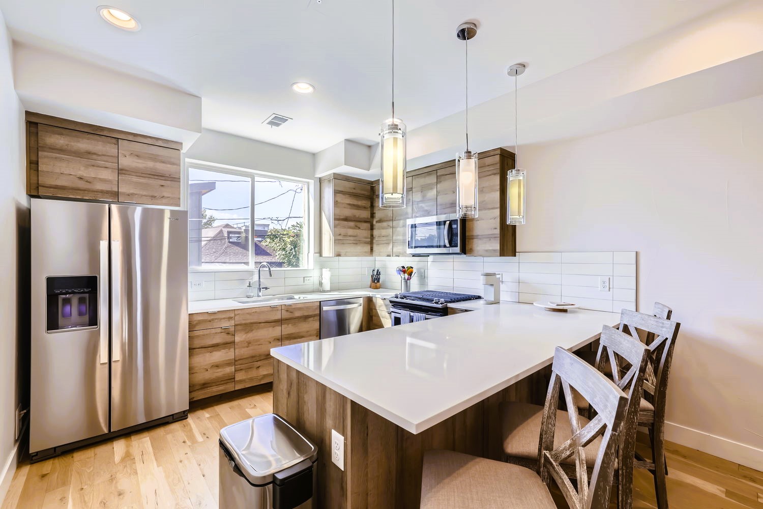 Cook your favorite meals in this stunning modern kitchen with stainless steel appliances, granite countertops, and warm wood cabinetry.