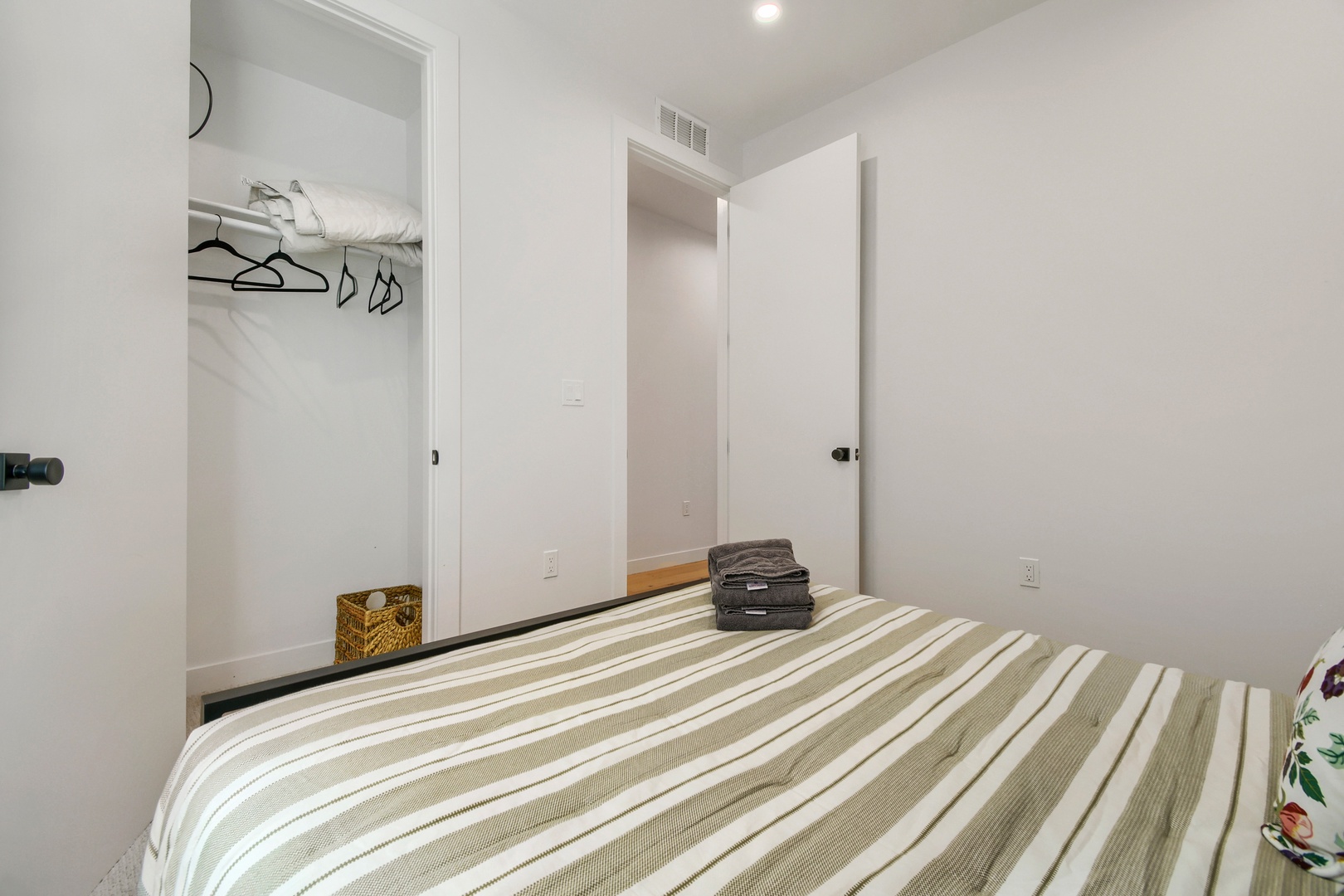 Your bedroom offers a calm, minimalist retreat with ample closet space and fresh linens. Unpack, unwind, and settle into your home away from home.