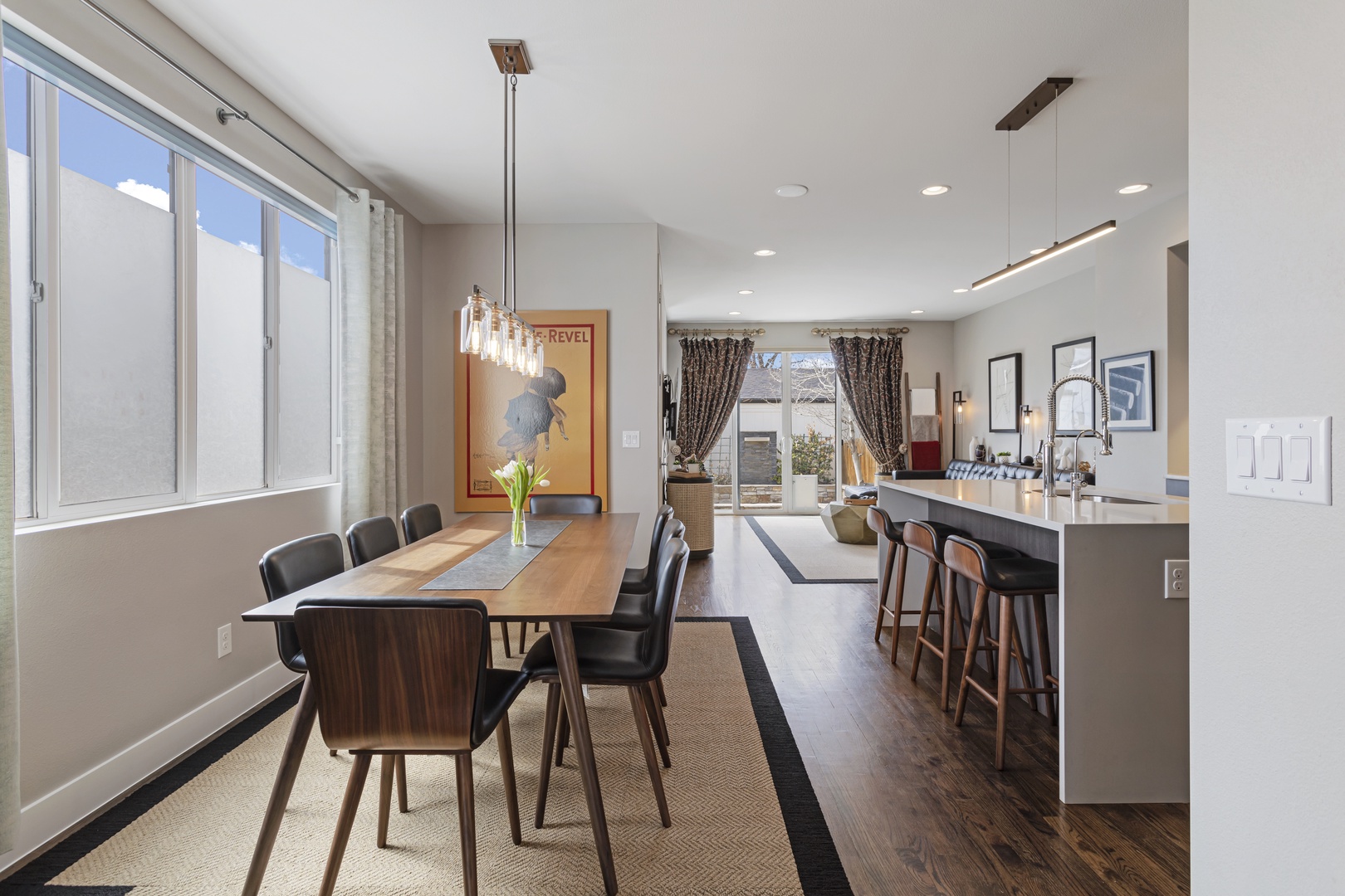 Your stylish open-plan dining and kitchen area features a sleek breakfast bar and elegant dining space perfect for memorable meals together.
