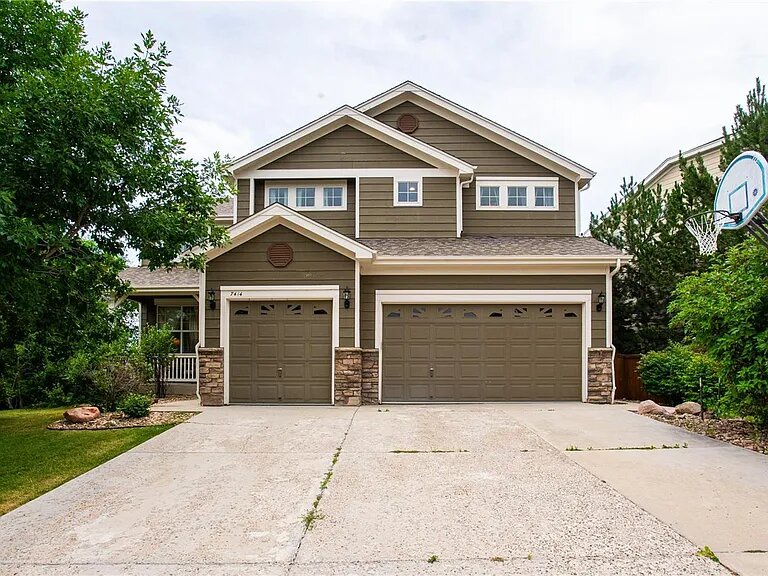 Modern two-story home with spacious garage and landscaped front yard in quiet residential neighborhood.