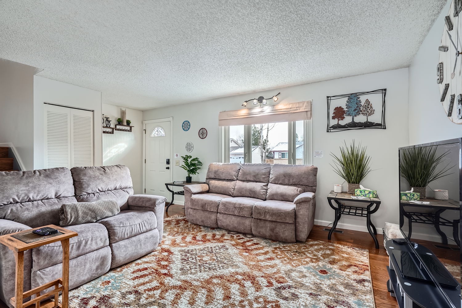 Settle into your bright, inviting living space with plush seating and natural light streaming through large windows, creating a warm atmosphere perfect for unwinding after your day.