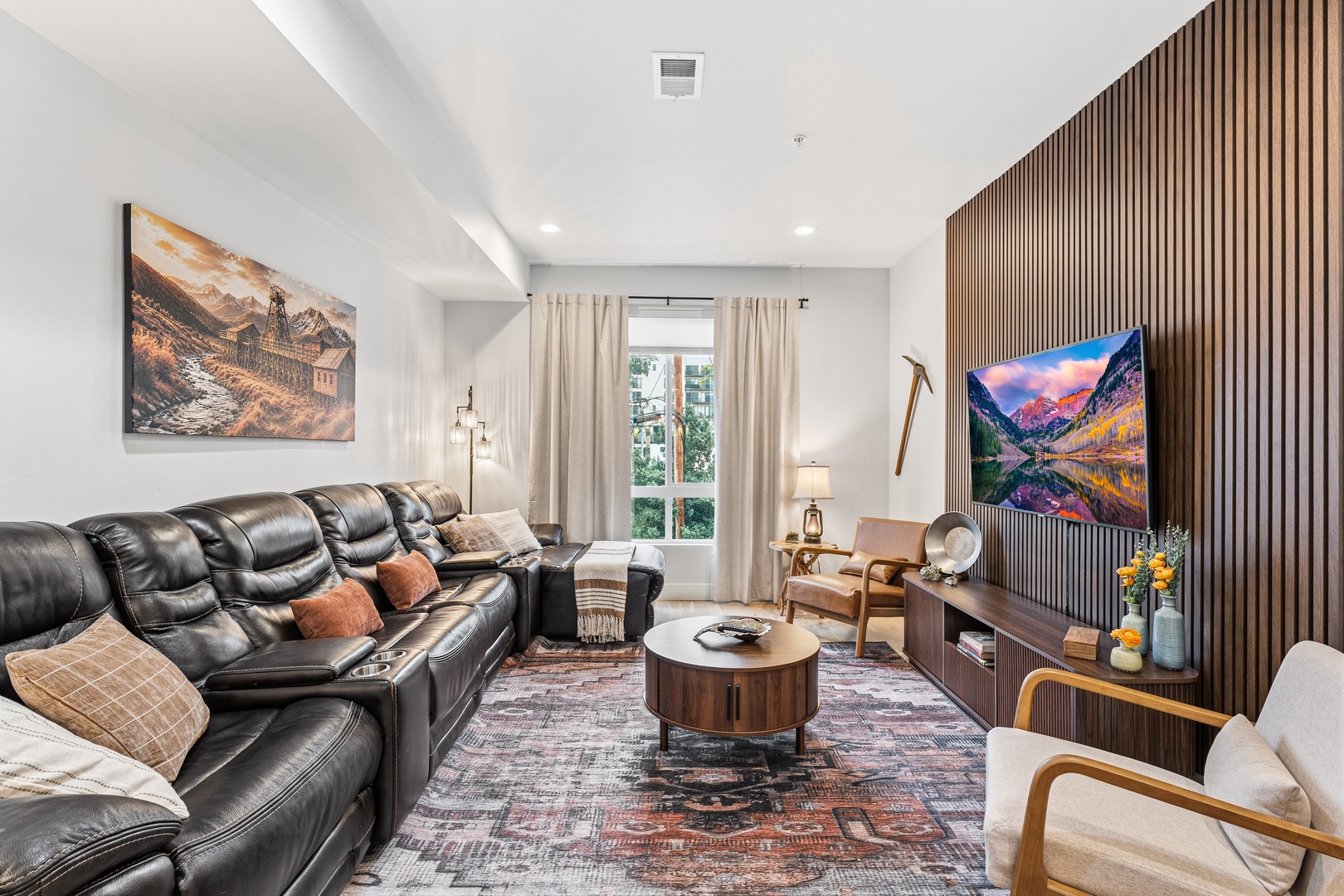 Your spacious living room blends comfort and style, with plush seating, natural light, and a stunning entertainment wall. Perfect for movie nights or relaxing after exploring nearby attractions.