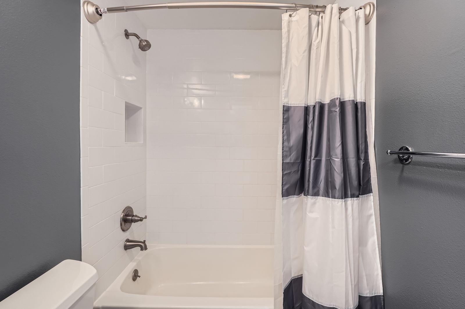 Step into your clean, modern bathroom with a spacious tub-shower combo perfect for unwinding after exploring.