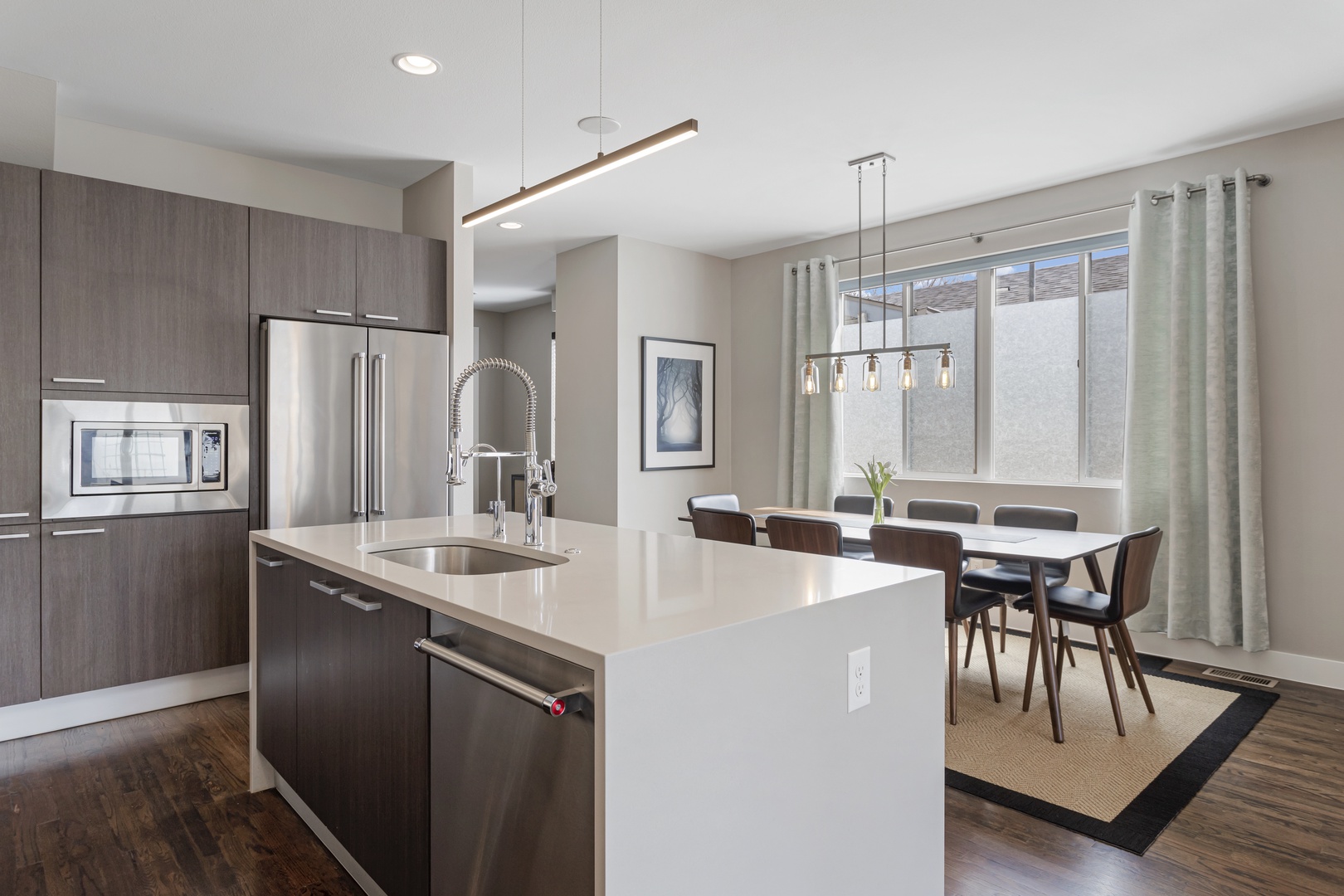 Your modern kitchen flows seamlessly into the dining area, where you'll love cooking with sleek appliances and entertaining around the stylish table.