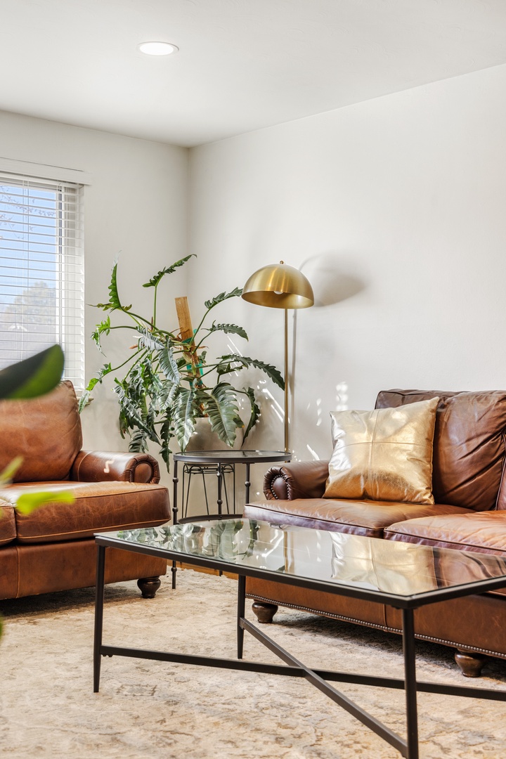 Sink into rich leather seating with warm ambient lighting and vibrant greenery creating your perfect relaxation haven.