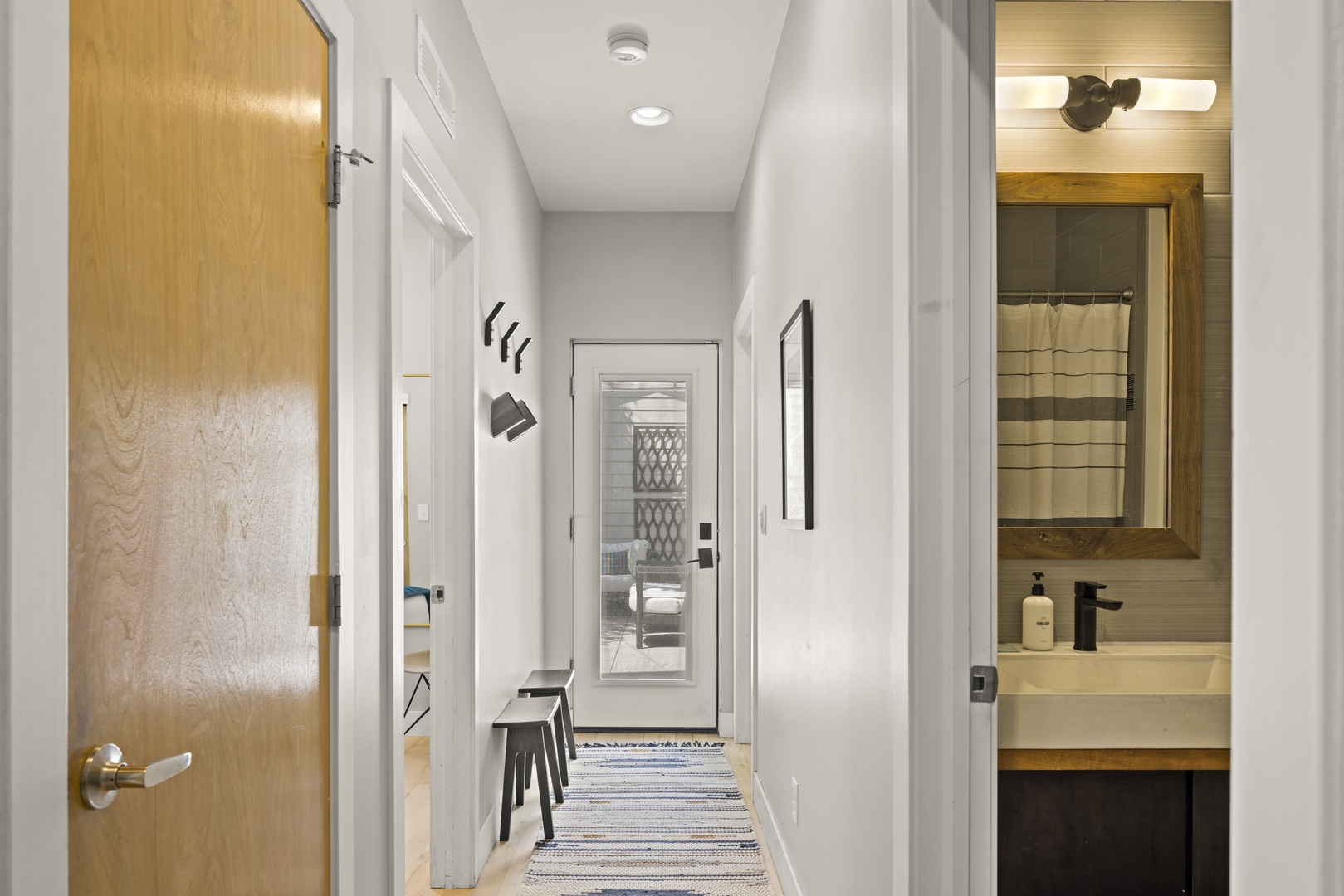 Step into your bright, modern hallway where thoughtful design meets comfort—clean lines and warm wood accents create a welcoming entry to your space.