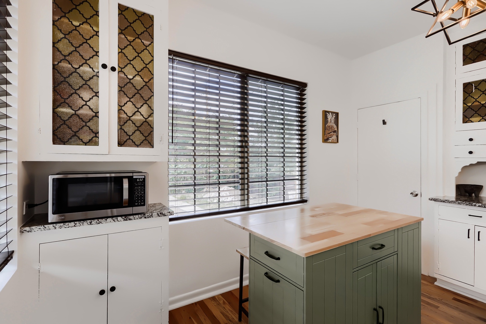 Your bright, fully-equipped kitchen awaits with modern appliances, a charming island workspace, and stylish details—perfect for preparing meals during your stay.
