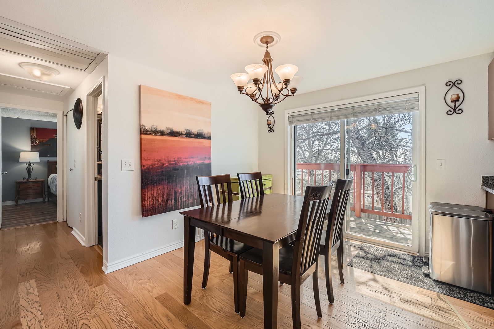 Gather around your elegant dining table where warm chandelier light creates perfect ambiance for memorable meals together.