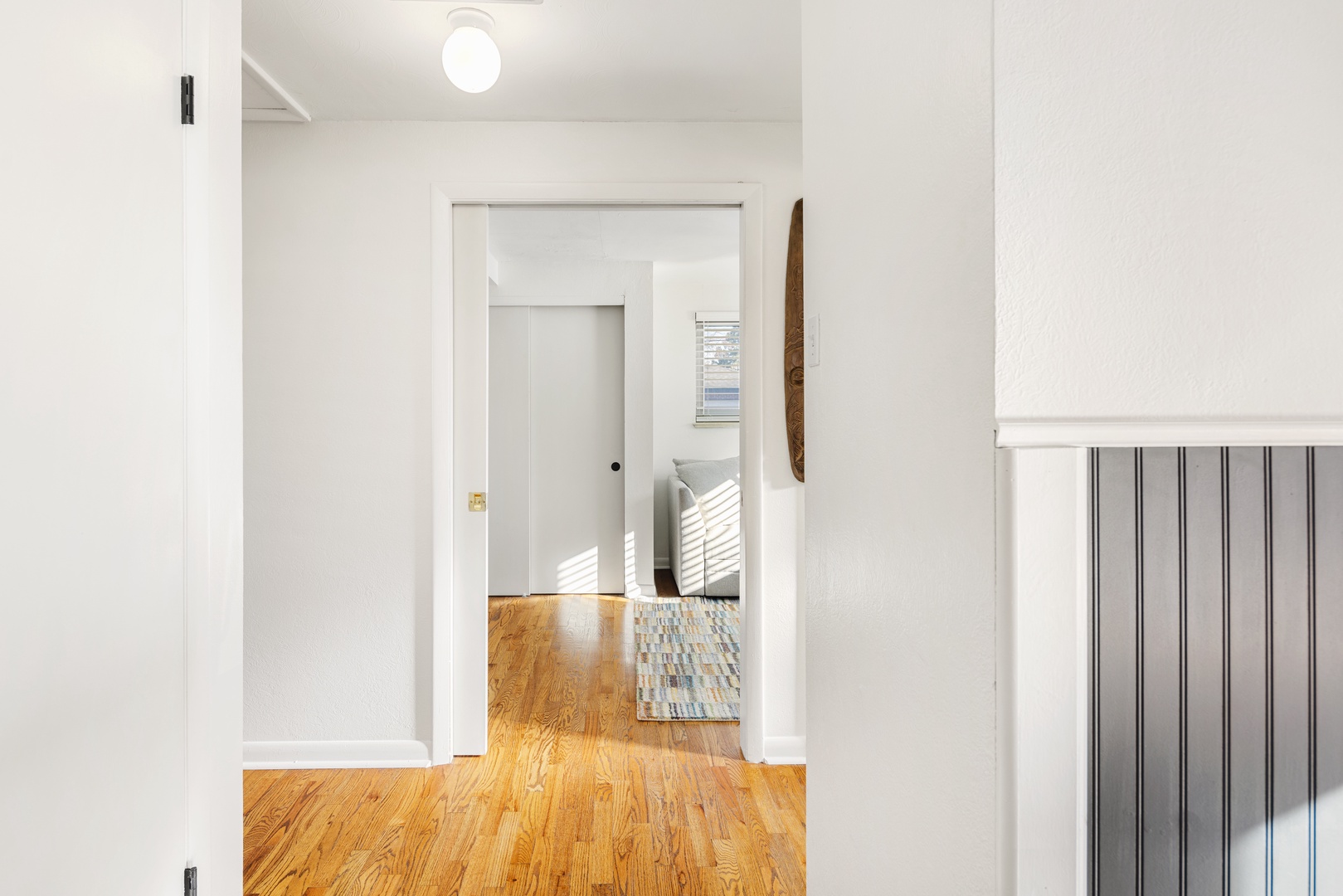 Step into your bright, airy hallway where warm hardwood floors guide you through this thoughtfully designed space.