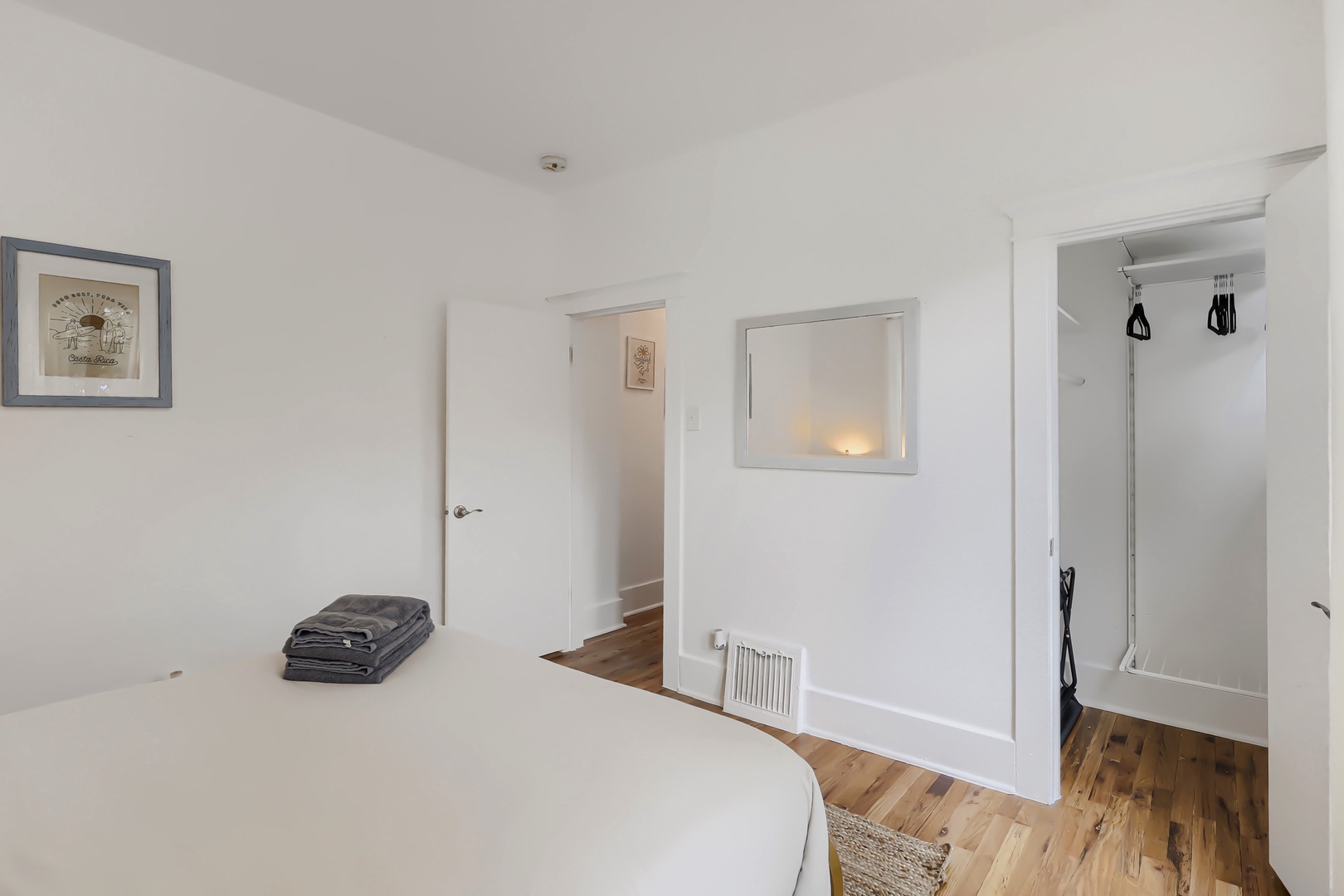Your bright, tranquil bedroom awaits with crisp white linens, warm wood floors, and thoughtful touches like art and ample closet space for settling in.