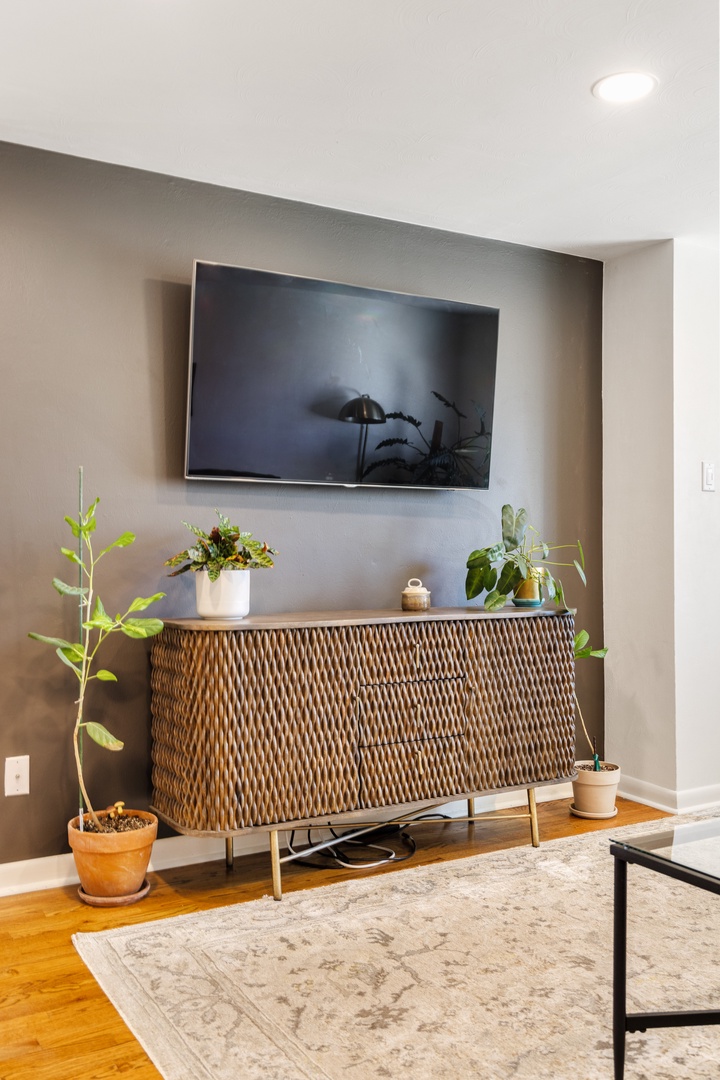 Unwind in your stylish living space with modern amenities, textured furnishings, and lush greenery creating the perfect atmosphere for relaxation.