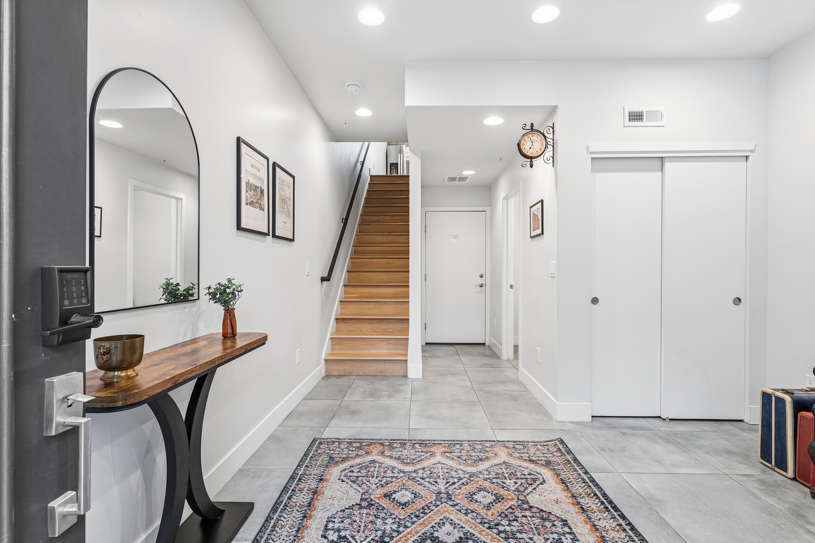 Step inside your stylish entryway with modern design and warm wood accents. The welcoming staircase leads to your private upper-level spaces.