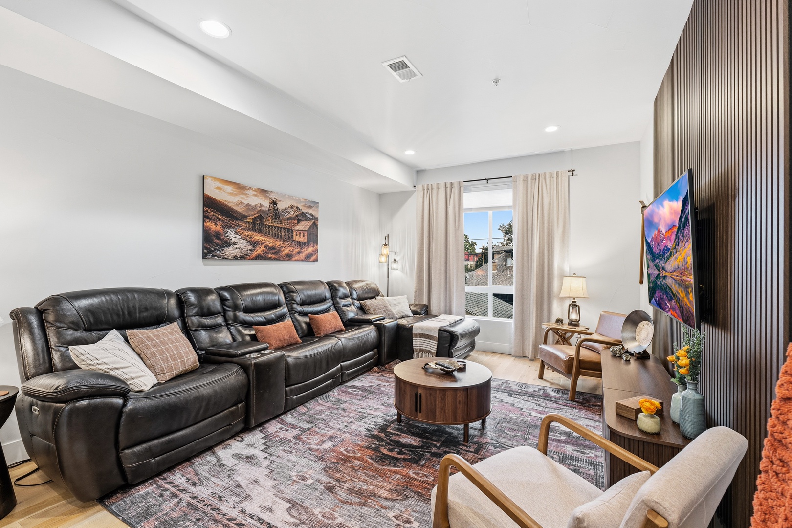 Sink into this plush leather sectional after your day exploring—your private retreat features a bright, open layout with stylish accents and natural light streaming through floor-to-ceiling windows overlooking the pool.