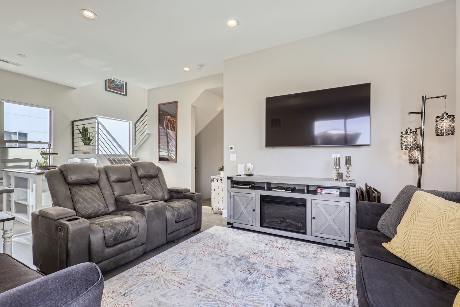 Sink into plush seating and unwind in your bright, modern living room. With a cozy fireplace and stylish touches, this space invites you to relax after exploring nearby attractions.