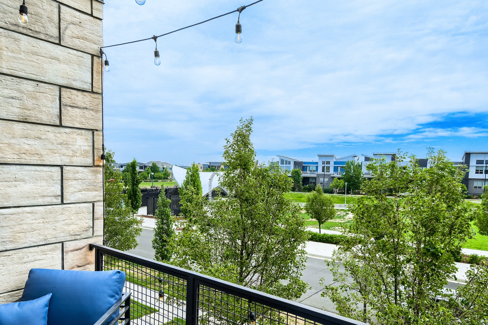 A modern residential neighborhood featuring contemporary homes, tree-lined streets, and well-maintained green spaces sits just beyond the property.